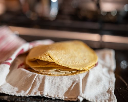 stack of fresh warm tortillas in a cloth basket