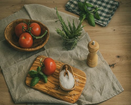 fresh quelites and chilies on a rustic wooden table