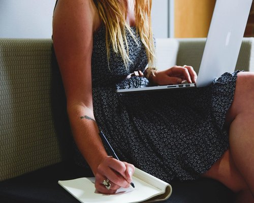 person drinking water while working from home